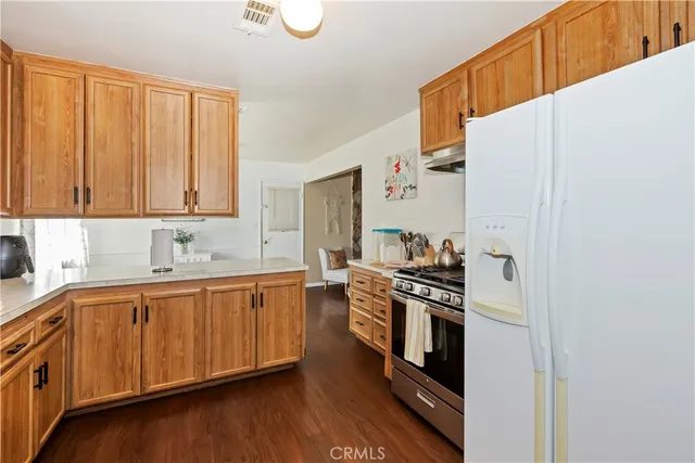 a kitchen with stainless steel appliances a stove a sink and cabinets