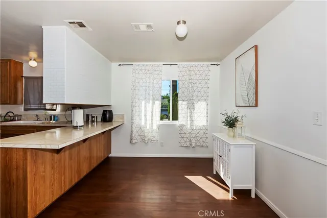 a large white kitchen with a large window