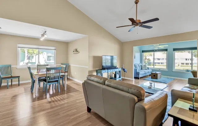 a living room with furniture a window and a dining table