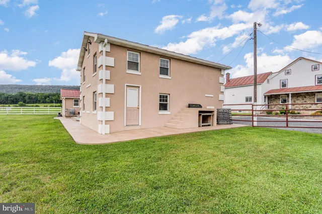 a view of a house with a yard and garage