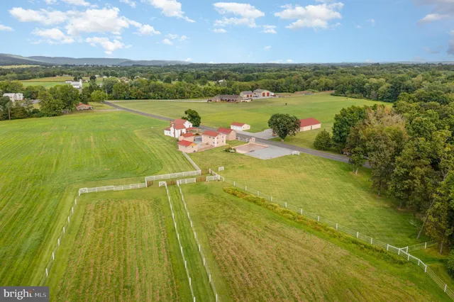 a view of a swimming pool with lawn chairs under an umbrella