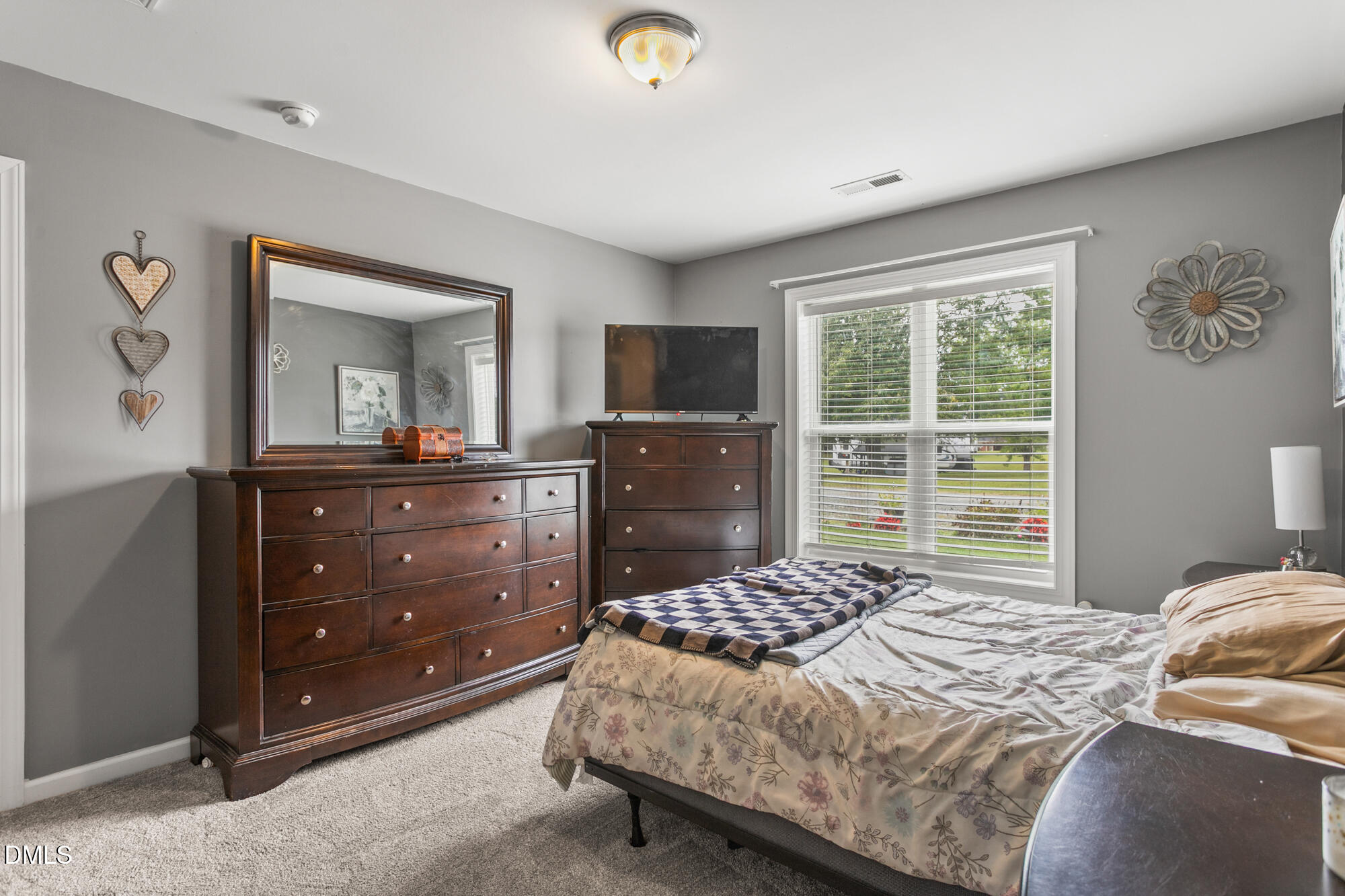 3163 Saul Loop Road Elon, NC 27244 - Photo 29 of 44 a bedroom with a bed and a television on dresser