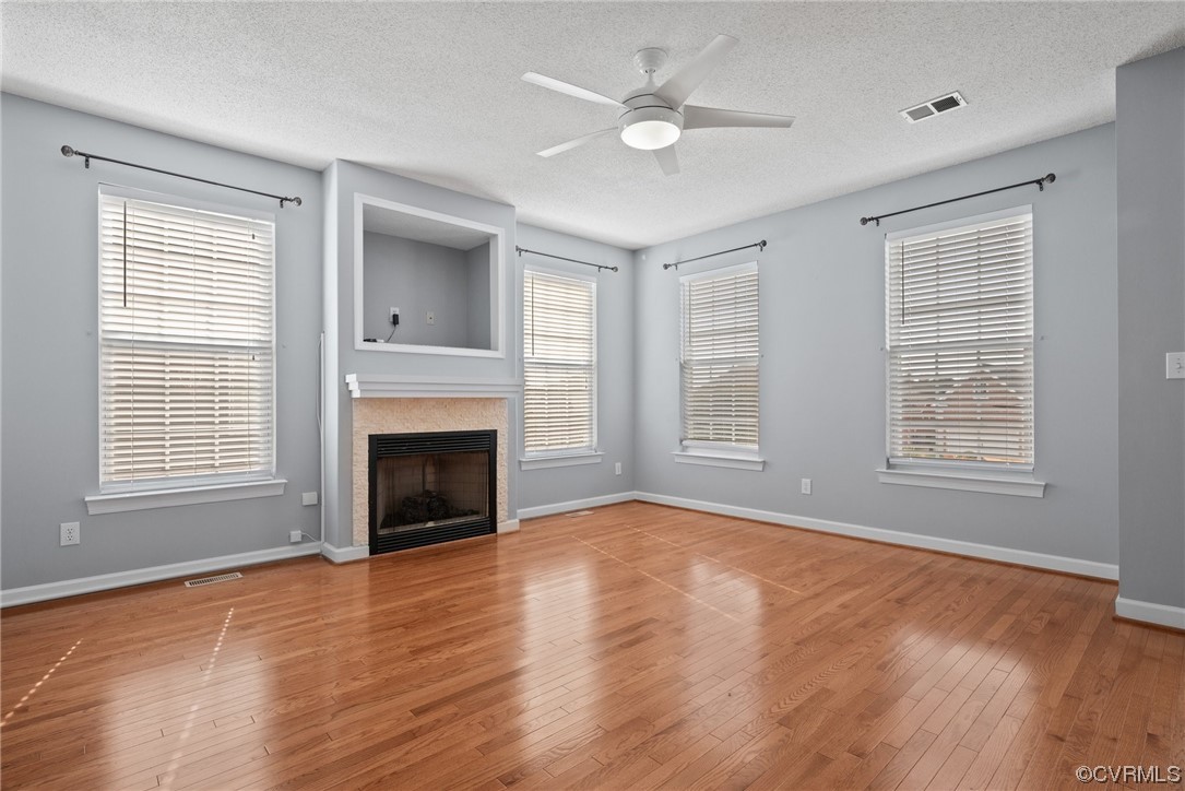 15 Brough Lane Hampton, VA 23669 - Photo 24 of 43 an empty room with windows fireplace and wooden floor