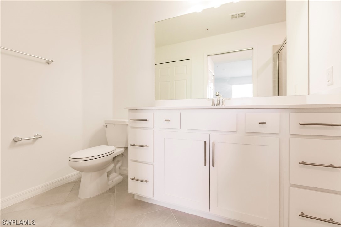 43997 Boardwalk Loop, Unit 1818 Punta Gorda, FL 33982 - Photo 21 of 40 a bathroom with a toilet sink and mirror