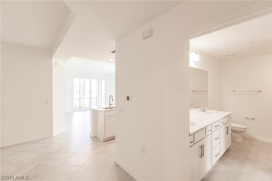 43997 Boardwalk Loop, Unit 1818 Punta Gorda, FL 33982 - Photo 27 of 40 a bathroom with a sink toilet and mirror