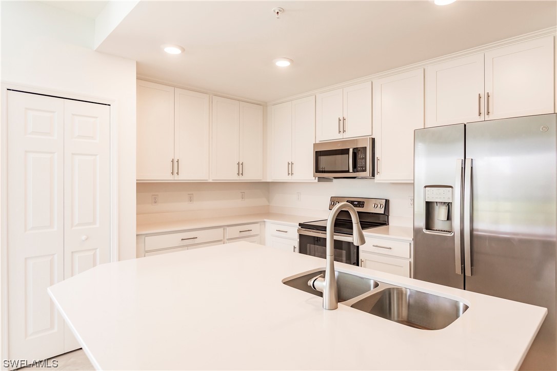 43997 Boardwalk Loop, Unit 1818 Punta Gorda, FL 33982 - Photo 3 of 40 a kitchen with stainless steel appliances granite countertop a sink and a refrigerator