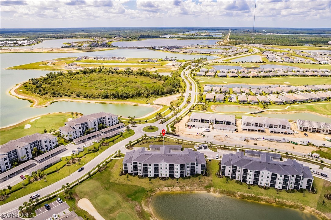 43997 Boardwalk Loop, Unit 1818 Punta Gorda, FL 33982 - Photo 35 of 40 a view of a swimming pool with a table and chairs