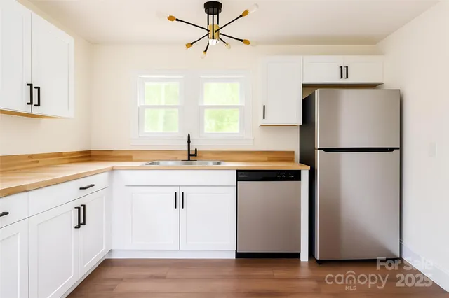 a kitchen with a refrigerator and a sink