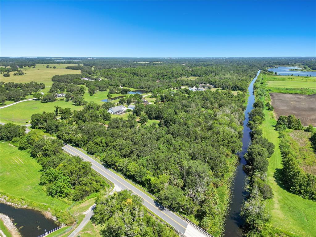 26000 Splendid Meadow Court Astatula, FL 34705 - Photo 5 of 12 an aerial view of residential houses with outdoor space and trees
