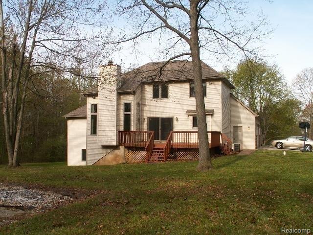2589 Fisk Road Howell, MI 48843 - Photo 2 of 9 Large Deck Wooded property