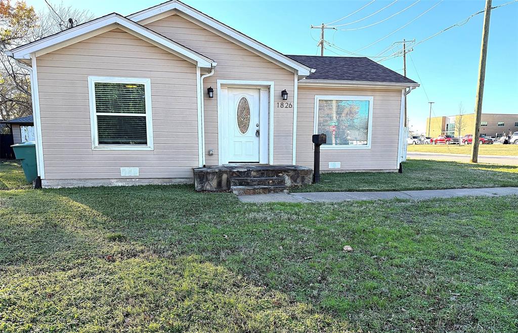 1826 North Woods Street Sherman, TX 75092 - Photo 1 of 29 a front view of a house with garden