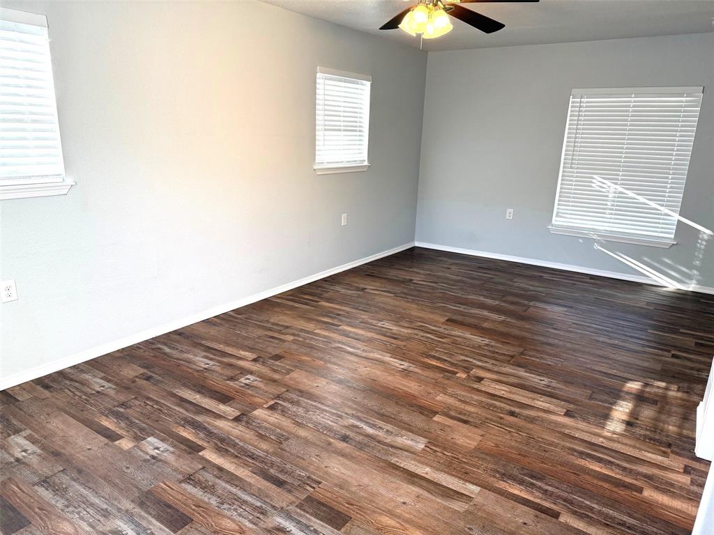 1826 North Woods Street Sherman, TX 75092 - Photo 16 of 29 an empty room with wooden floor fan and window