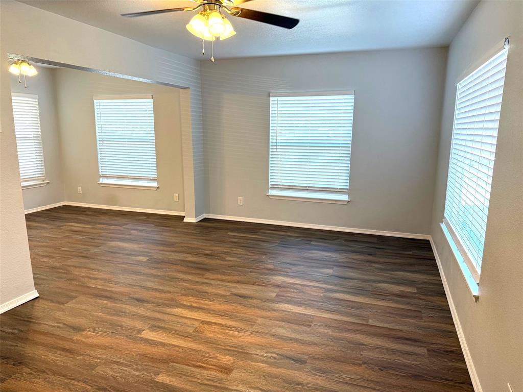 1826 North Woods Street Sherman, TX 75092 - Photo 2 of 29 an empty room with wooden floor and windows