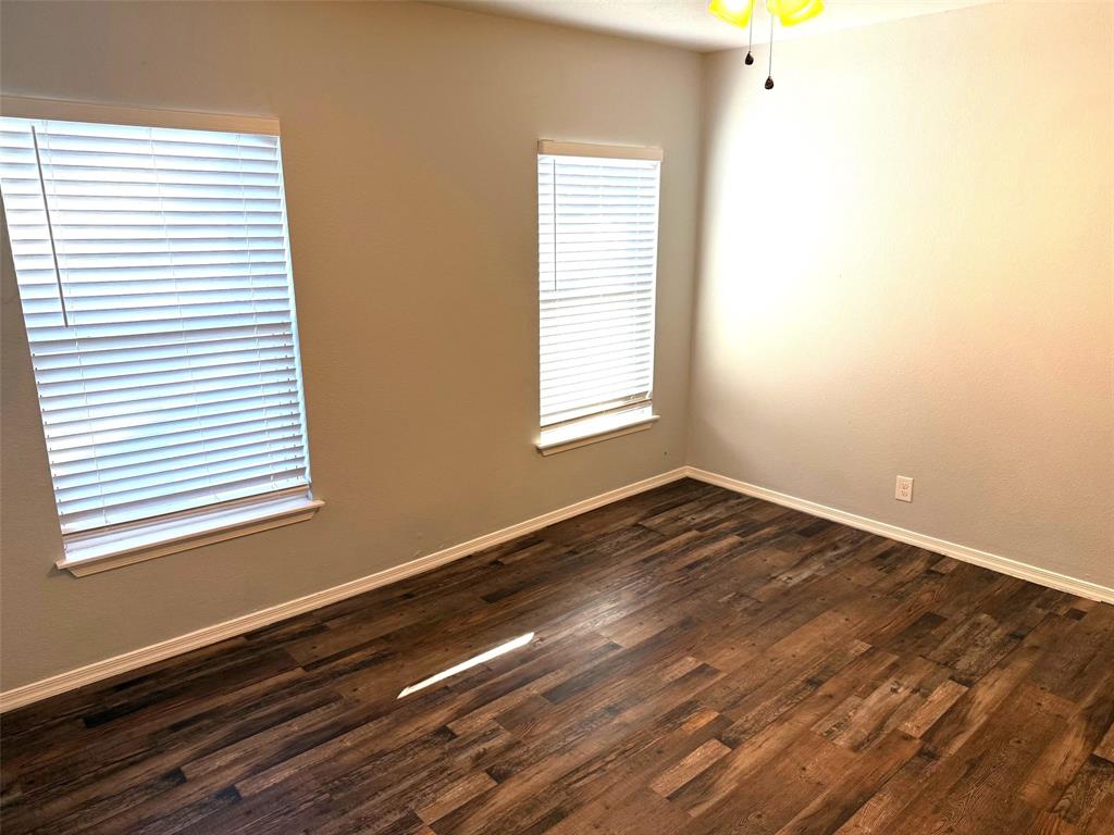 1826 North Woods Street Sherman, TX 75092 - Photo 21 of 29 a view of an empty room with wooden floor and a window