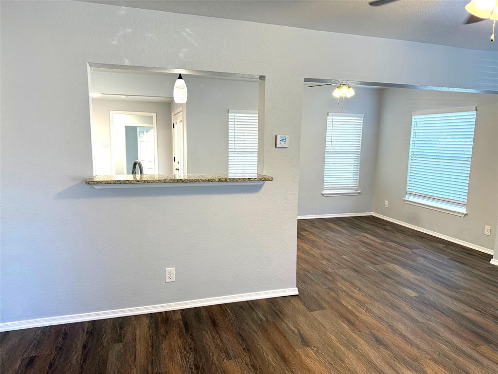 1826 North Woods Street Sherman, TX 75092 - Photo 4 of 29 an empty room with wooden floor and windows