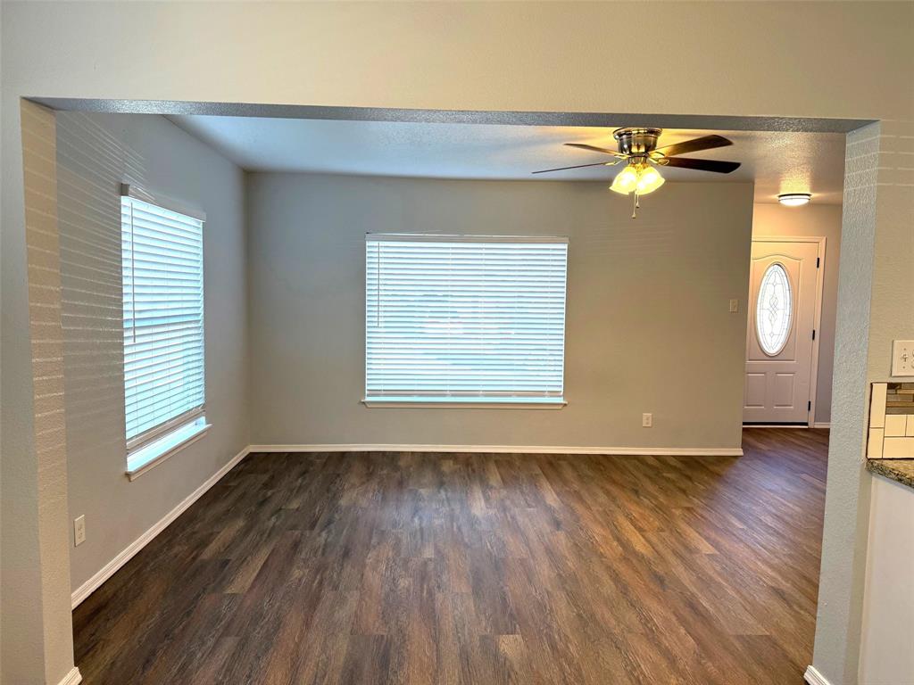 1826 North Woods Street Sherman, TX 75092 - Photo 6 of 29 an empty room with wooden floor and windows