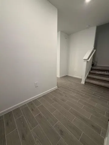 a view of an empty room with stairs