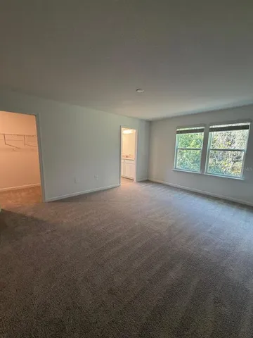 a view of an empty room with windows