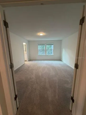 a view of an empty room and a window