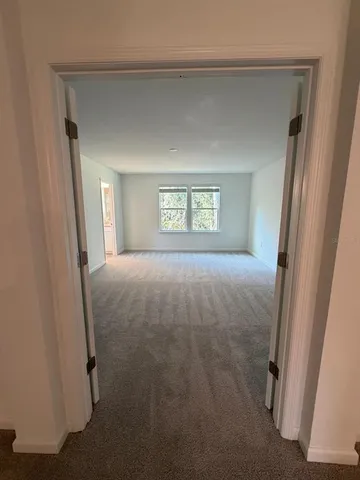 a view of livingroom with window and front door