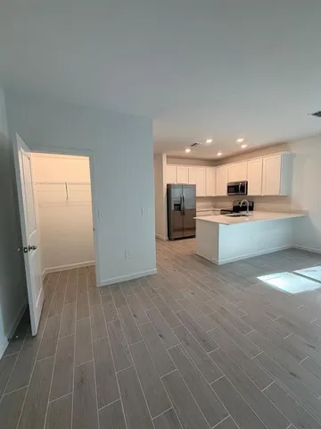 a view of a kitchen with a sink cabinets and a window