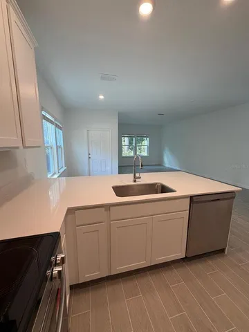 a spacious bathroom with a sink and mirror