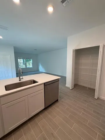 a room with a sink and cabinets