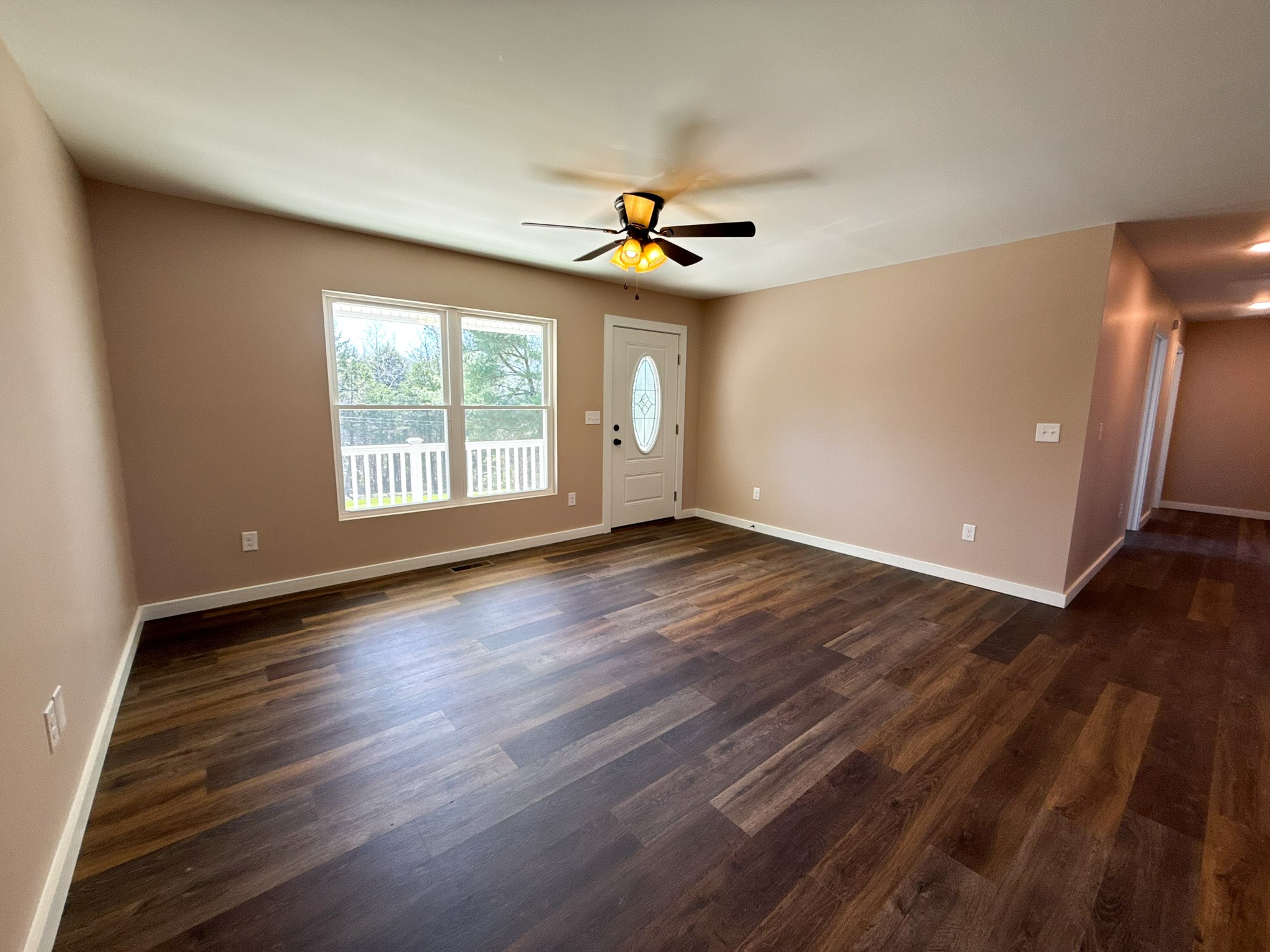 44 Blue Lake Road McMinnville, TN 37110 - Photo 13 of 30 an empty room with wooden floor chandelier fan and windows