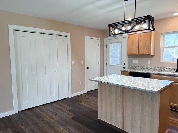 a kitchen with a sink a cabinets and window