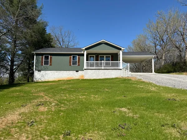 a front view of house with yard and green space