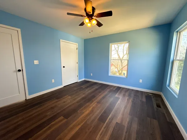 wooden floor in an empty room with a window
