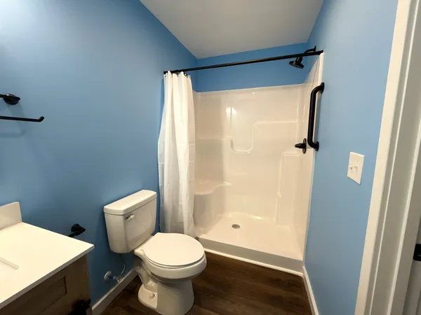 a bathroom with a toilet and a shower