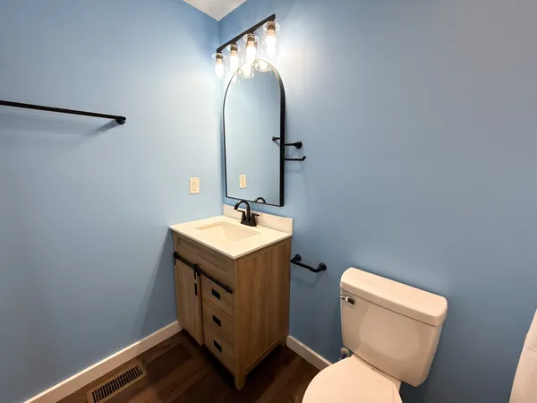 a bathroom with a toilet sink and mirror