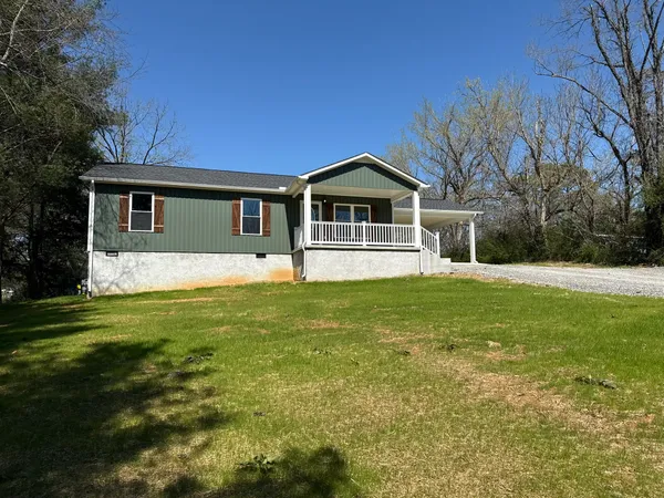a front view of house with yard and green space
