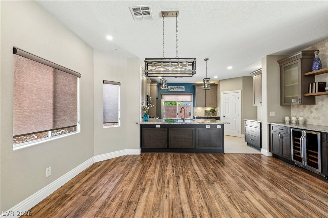 1176 Butternut Ranch Court Henderson, NV 89052 - Photo 8 of 60 An open-concept living space with a gourmet kitchen, hardwood flooring, and ample natural light.