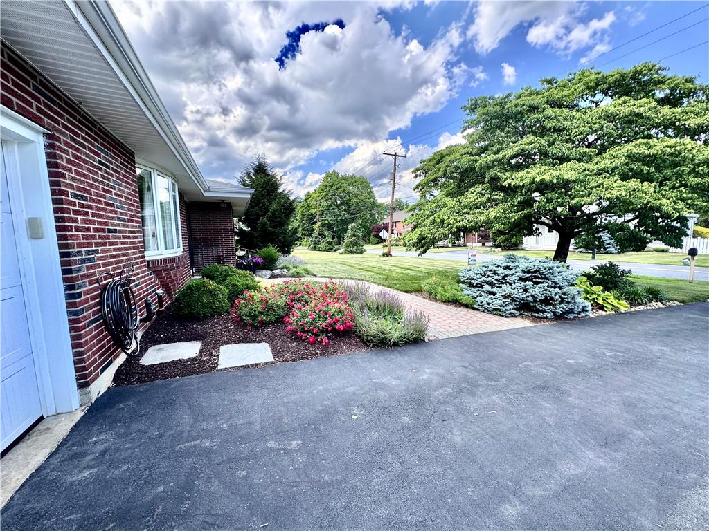 5334 Egypt Road Laurys Station, PA 18059 - Photo 55 of 55 Mature trees frame this charming brick home with well-tended landscaping and a paved driveway.