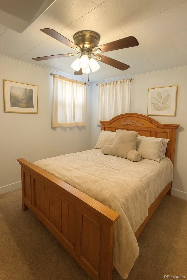 2355 Ames Street Edgewater, CO 80214 - Photo 12 of 29 a bedroom with a bed and a chandelier
