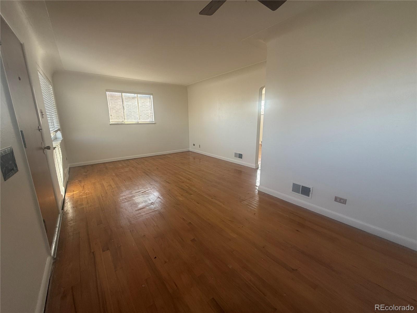 2355 Ames Street Edgewater, CO 80214 - Photo 25 of 29 an empty room with wooden floor and windows