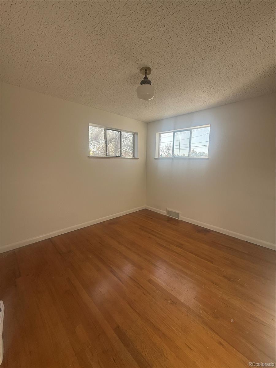 2355 Ames Street Edgewater, CO 80214 - Photo 9 of 29 a view of empty room with wooden floor and fan