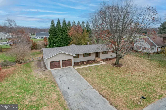 an aerial view of a house with a yard lake view and mountain view