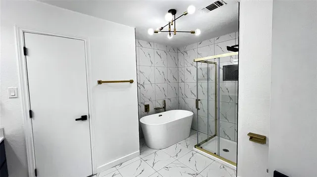 a bathroom with a bathtub and shower
