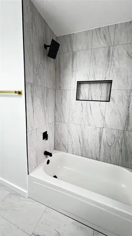 a bathroom with a bathtub and a shower