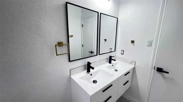 a bathroom with a sink and mirror