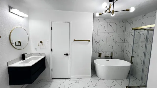 a bathroom with a bathtub sink mirror and toilet