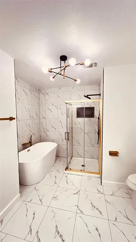 a bathroom with a bathtub and shower