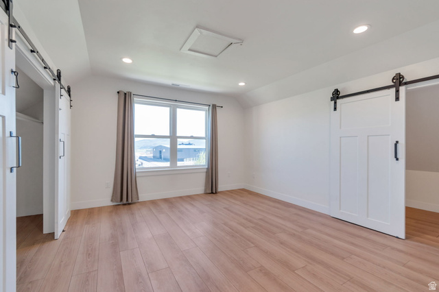 1820 West Farmhouse Flats Road Peoa, UT 84061 - Photo 52 of 79 Spacious room featuring light wood-finish flooring, recessed lighting, and a window with neutral drapes
