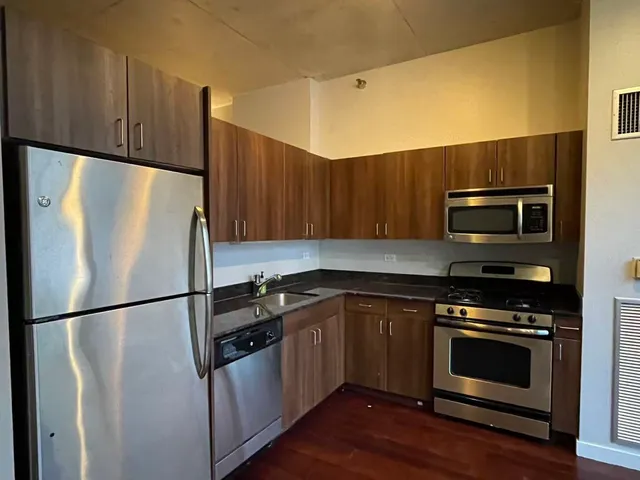 a kitchen with a refrigerator sink and microwave