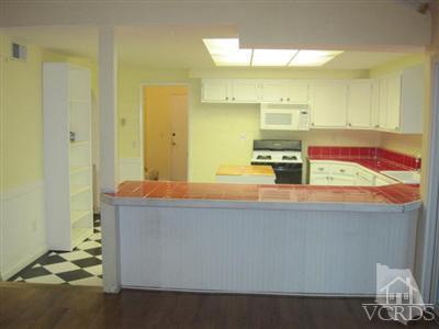 4347 Apricot Road Simi Valley, CA 93063 - Photo 13 of 19 a room with kitchen island a sink a stove and a refrigerator