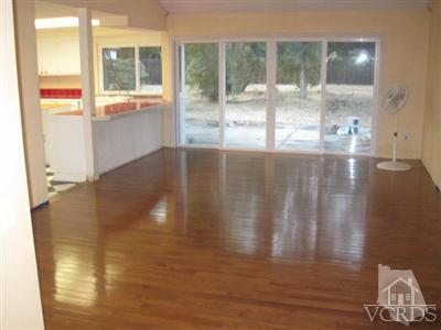 4347 Apricot Road Simi Valley, CA 93063 - Photo 10 of 19 a view of an empty room with wooden floor and a window