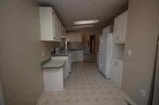 1580 Turner Branch Road Goodview, VA 24095 - Photo 8 of 19 a kitchen with refrigerator and cabinets